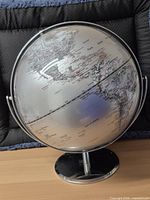 Front view of globe showing North America and chrome meridian