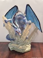 Front view of blue ice dragon on crystal base