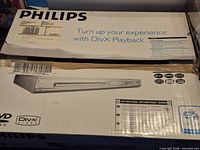 Retail box showing Philips branding, model image, DivX playback info