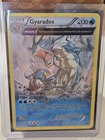 Card in toploader showing full front artwork and holo pattern