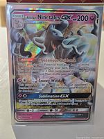 Front of sleeved Alolan Ninetales GX card showing holographic artwork and text