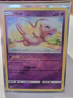 Front view of sleeved Mew reverse holo card showing artwork and condition