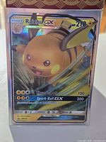 Front of sleeved Raichu GX SM213 card showing holographic foil and stats