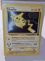 Front of Pikachu promo card showing artwork, 50 HP, WB stamp, wear