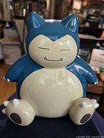Front view of ceramic Snorlax piggy bank