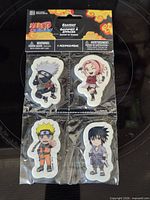 Front view of sealed 4-pack showing all four character erasers