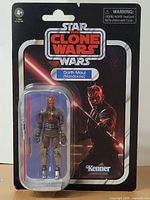 Front of card showing sealed Darth Maul figure and accessory