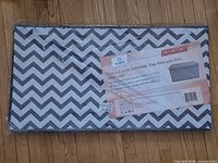 Front view of sealed Woffit toy storage box showing label and chevron design