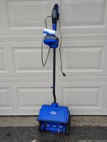Full view of Snow Joe 320E corded electric snow shovel standing upright