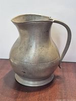 Side view showing pitcher profile and handle