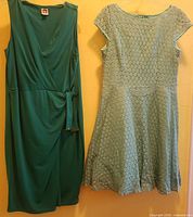 Both dresses hanging side by side showing overall styles and colors
