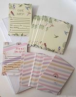 Both packs of invitation cards showing designs, envelopes visible