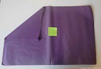 Stack of folded dark purple tissue paper sheets