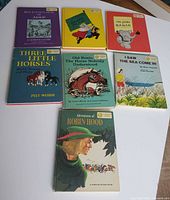 Group shot displaying all seven books laid out