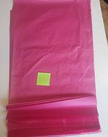 Stack of folded dark pink tissue paper sheets