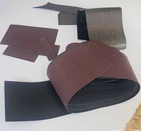 Rolled brick and stone sheets with cut pieces displayed