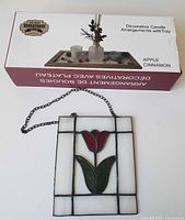 Boxed Home Sensations candle tray set beside stained glass tulip panel