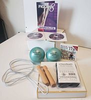 Group shot showing DVDs, Miracle Balls, booklet, TheraBand package, jump rope