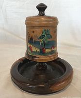 Front view showing painted scene, lid, base