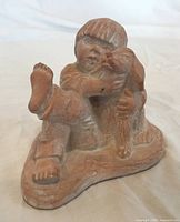 Front view of ceramic boy with dog sculpture