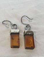 Front view of both amber and sterling silver earrings