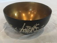 Side view showing black exterior and silver bamboo motif