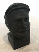 Front three-quarter view of bronze bust showing facial detail and base