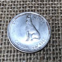 Reverse of 1967 Canadian Centennial 50-cent coin showing howling wolf and inscription CANADA 1867-1967 50 CENTS