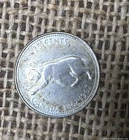 Reverse showing bobcat design and inscriptions 25 CENTS CANADA 1867-1967