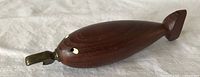 Top view teak whale bottle opener showing brass opener and eyes