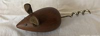Side view of teak mouse corkscrew showing body, ears, eyes and metal spiral