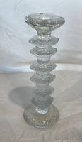 Full view of clear glass Festivo candlestick showing sticker on top