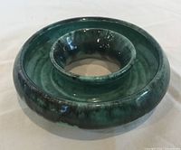 Top view showing circular green glazed bud vase with central opening