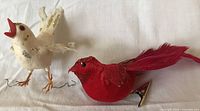 White and red bird ornaments side by side