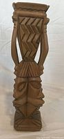 Full front view of carved African blonde wood sculpture