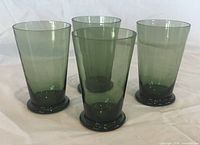 Front view of four olive green footed glasses