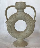 front view showing ring form, handles, decoration