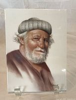 Front view of signed Gail Wilkinson portrait on porcelain plaque