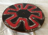 Top view showing red lava starburst pattern and center hole