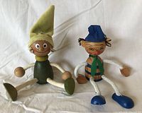Front view of both wooden elves seated