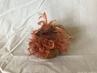 Side view of glittered bird ornament with peach feathers