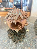 front view showing entry hole and leaf/acorn detail