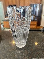 Full view of clear cut crystal vase on countertop