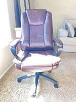 Front view of brown faux leather high-back swivel chair