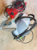 Overall lot including Steamfast steamer, Rowenta iron, red corded appliance