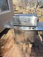 Front view of closed stainless steel grill showing overall condition