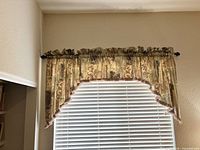 Valance mounted above window on wooden rod