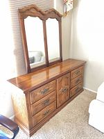 Front view of dresser with attached mirror showing drawer and cabinet configuration