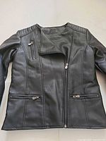 Front view of black leather biker jacket