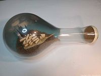 Full view of ship in glass bottle, showing overall size and shape